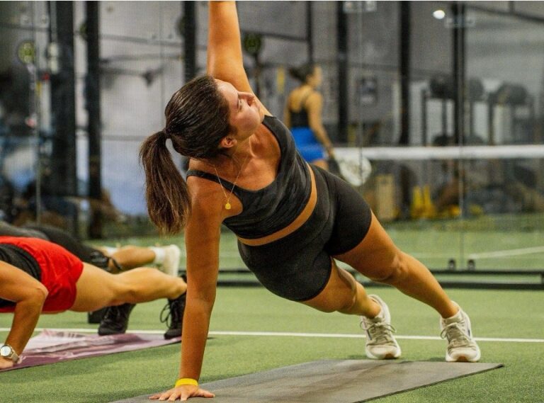 Member using strength training equipment inside Replay Club's luxury fitness center.