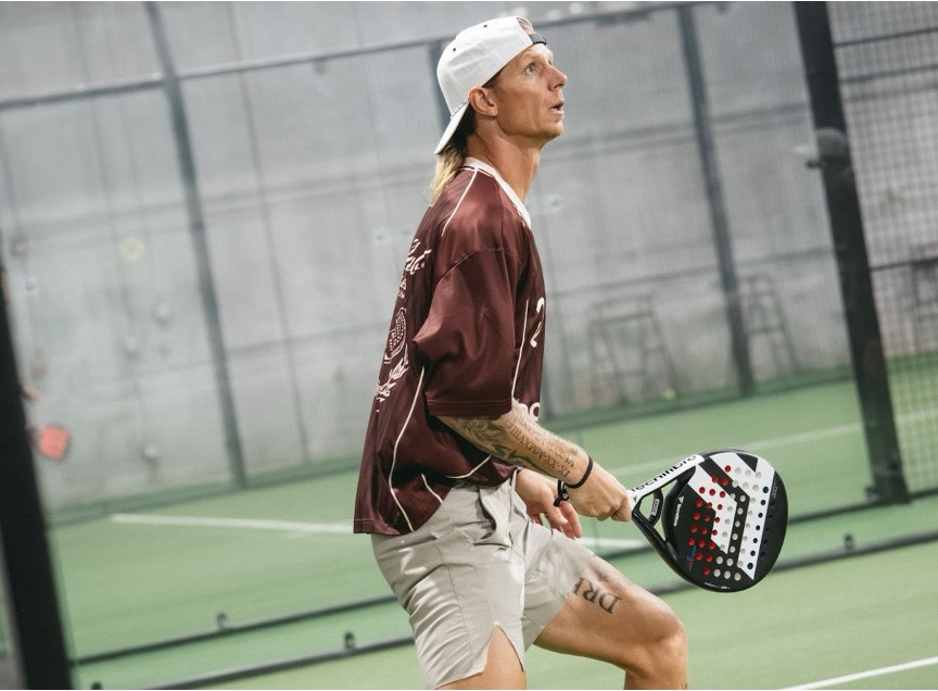 A Replay Club member playing padel in one of the club’s 10 climate-controlled indoor courts