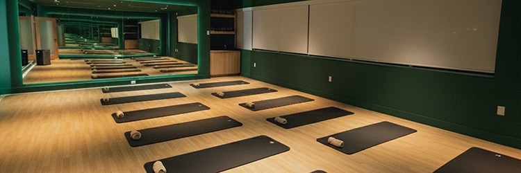 Spacious yoga and recovery studio with black mats