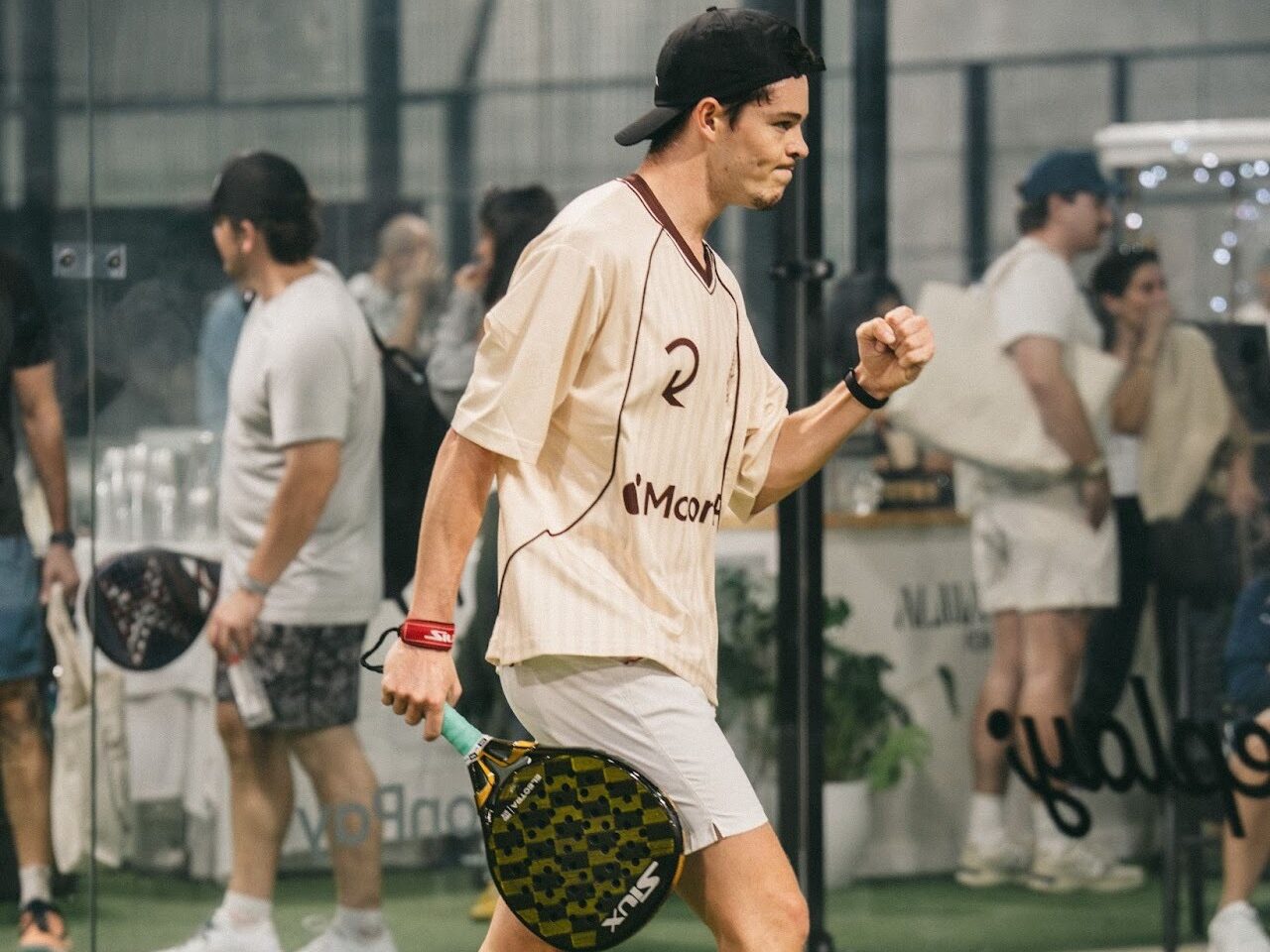 A member of Replay Club playing padel. 