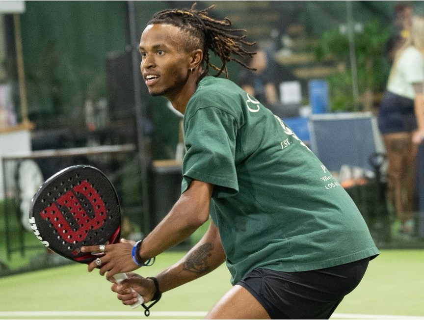 A member of Replay Club playing padel in one of the indoor climate-controlled courts