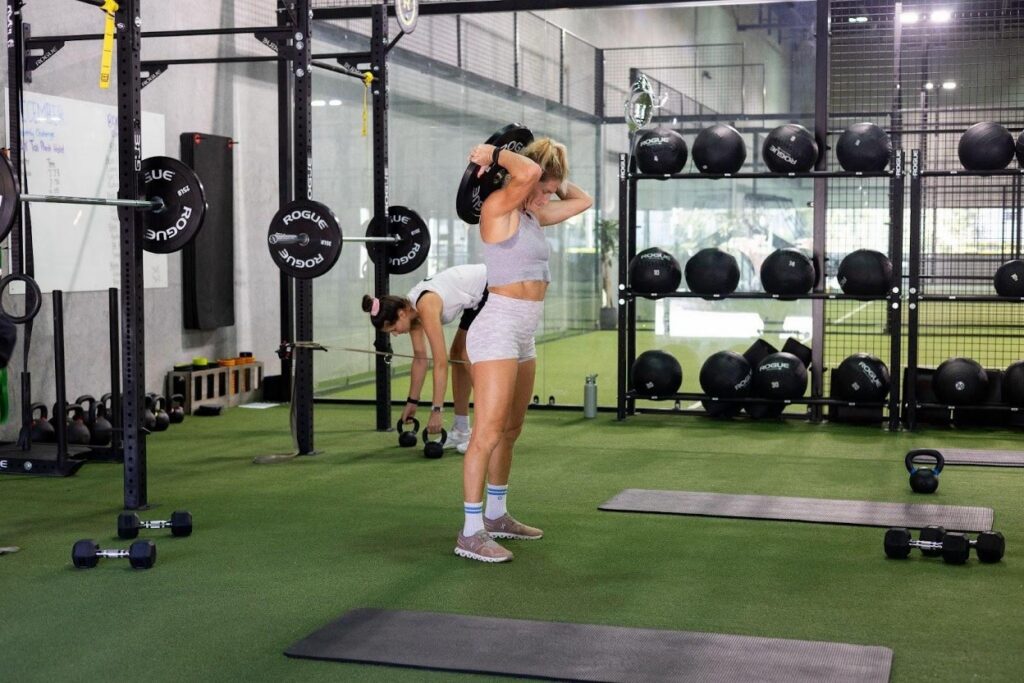 Replay Club gym floor with strength training equipment and open turf workout zones in Palm Beach County