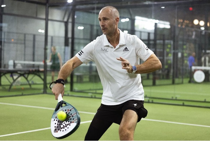 Replay Club member in a private padel coaching session on an indoor court near Lantana