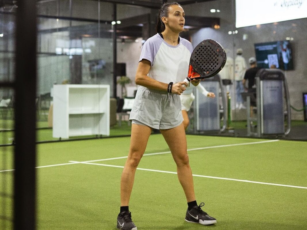Replay Club member playing padel on one of the indoor climate-controlled courts near Lantana.